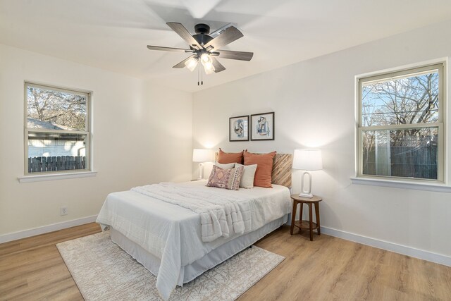 living area with light wood-style floors, recessed lighting, visible vents, and a ceiling fan