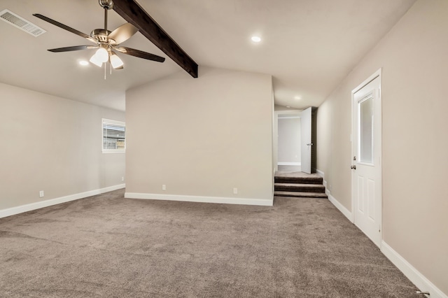 spare room featuring vaulted ceiling with beams, carpet, visible vents, and baseboards