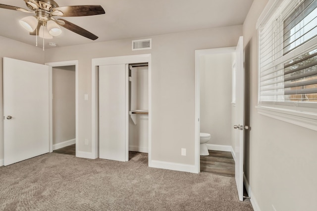 unfurnished bedroom with a closet, multiple windows, and carpet flooring