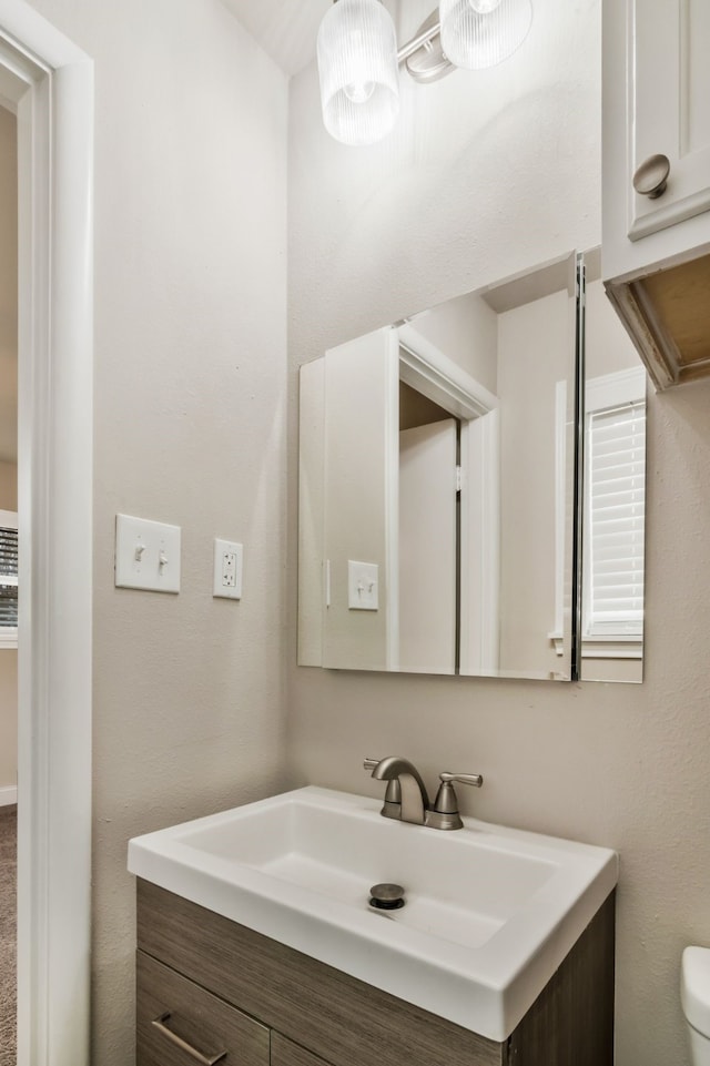 bathroom with toilet and vanity