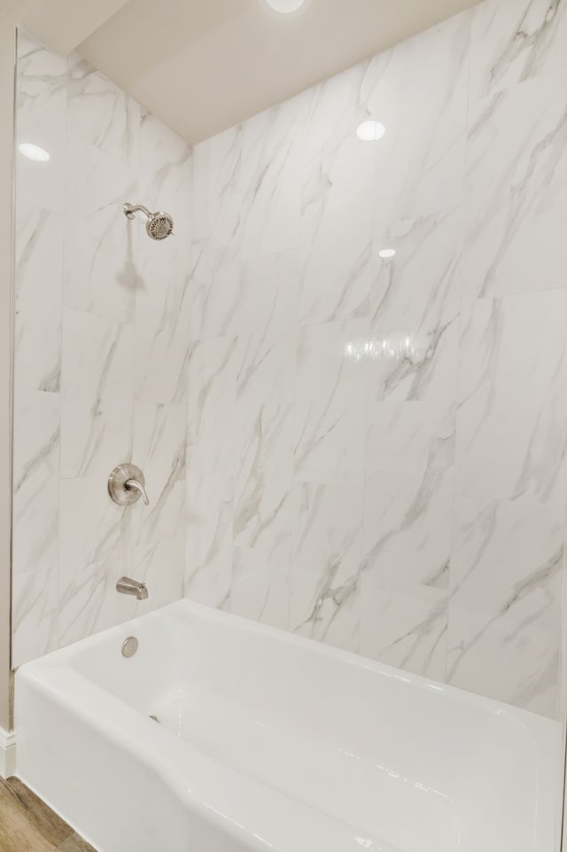 full bathroom featuring shower / washtub combination and wood finished floors