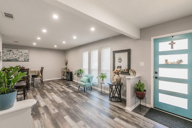 entryway with recessed lighting, visible vents, baseboards, and wood finished floors