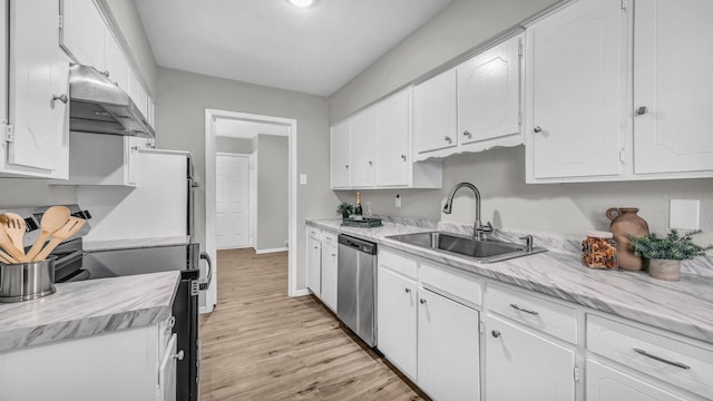 kitchen with stainless steel appliances, light countertops, a sink, and white cabinetry