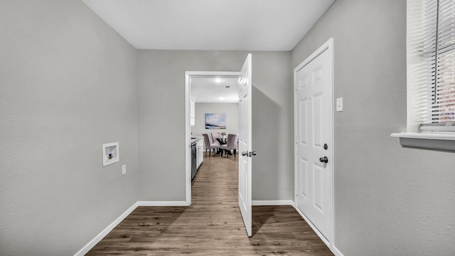 corridor with baseboards and wood finished floors