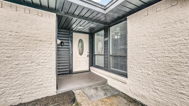 property entrance with brick siding