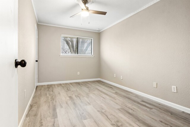 spare room with a textured wall, a ceiling fan, baseboards, ornamental molding, and light wood finished floors