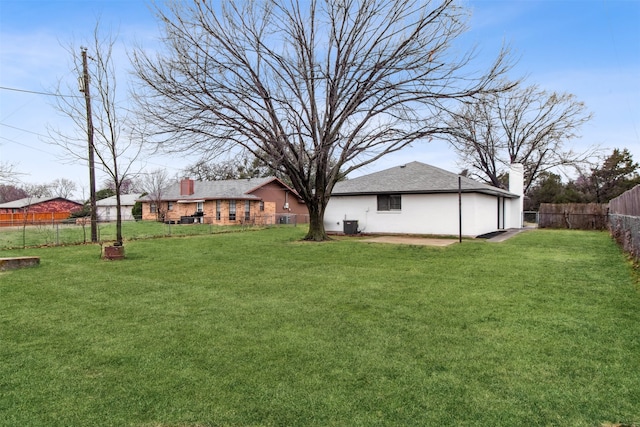 view of yard featuring a fenced backyard and central AC