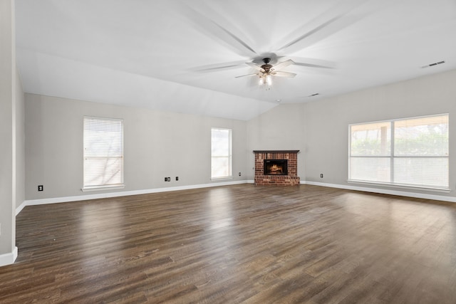 unfurnished living room featuring lofted ceiling, ceiling fan, a fireplace, and dark wood finished floors