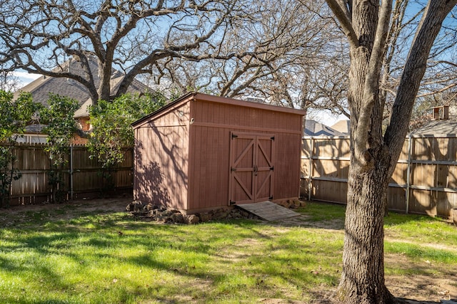 view of shed with a fenced backyard