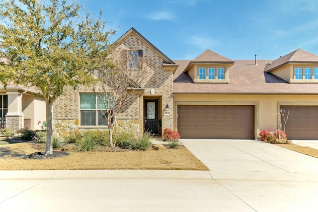 view of front of house featuring driveway, stone siding, roof with shingles, and stucco siding