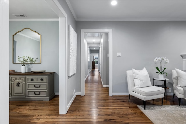 hall with crown molding, visible vents, dark wood finished floors, and baseboards