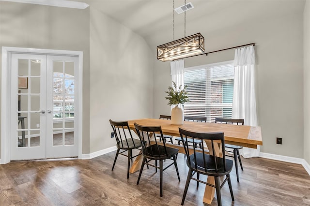 dining room featuring baseboards, visible vents, wood finished floors, and french doors