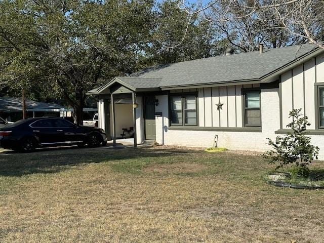 view of front of property featuring a front lawn and board and batten siding