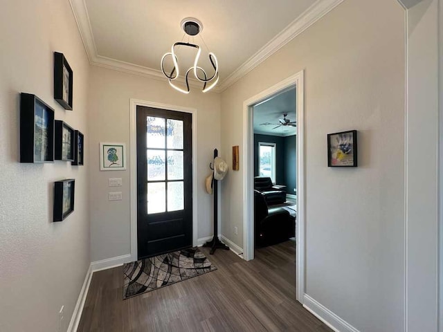 foyer featuring baseboards, an inviting chandelier, ornamental molding, and dark wood-type flooring