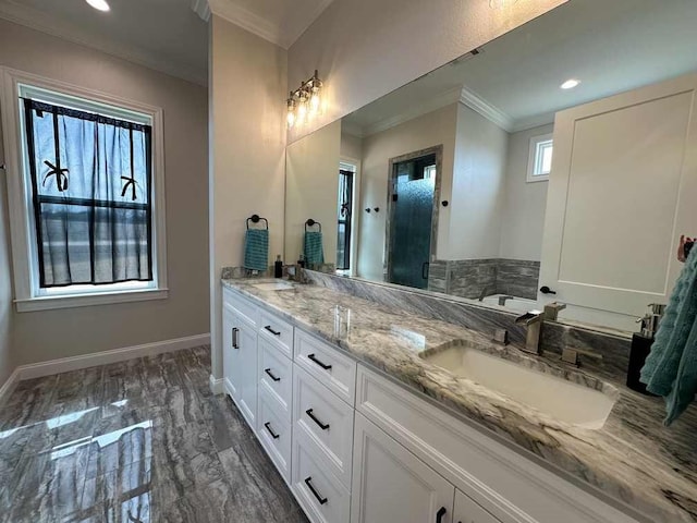 bathroom with double vanity, crown molding, a sink, baseboards, and marble finish floor