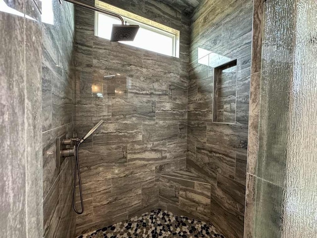 bathroom with a tile shower