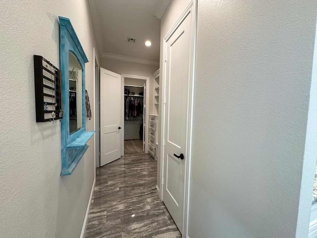hall featuring dark wood-style flooring, recessed lighting, baseboards, visible vents, and ornamental molding