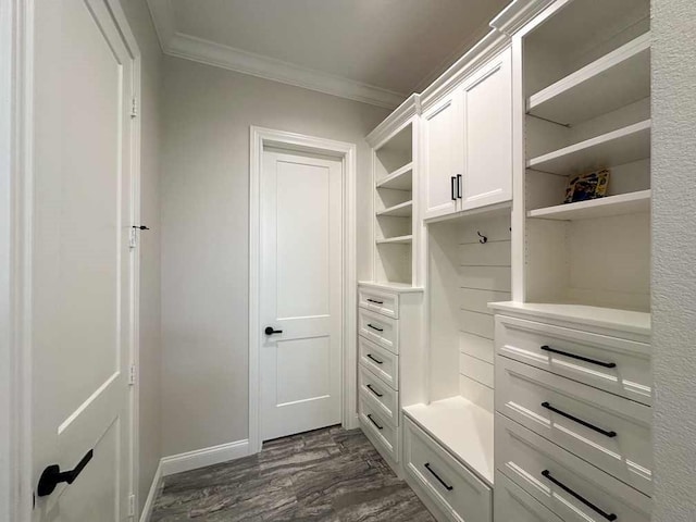 mudroom featuring crown molding, dark wood-style flooring, and baseboards