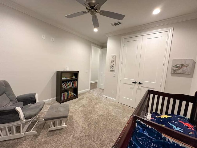 carpeted bedroom featuring visible vents, ornamental molding, baseboards, and a closet