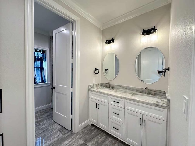 full bath with crown molding, a sink, baseboards, and double vanity