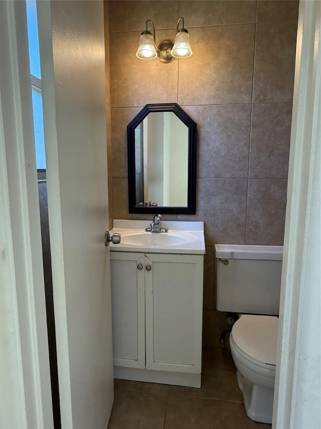 bathroom featuring tile walls, vanity, toilet, and tile patterned floors