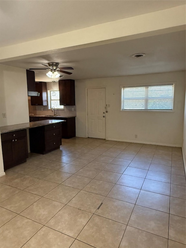 kitchen with a wealth of natural light, light countertops, visible vents, and light tile patterned floors