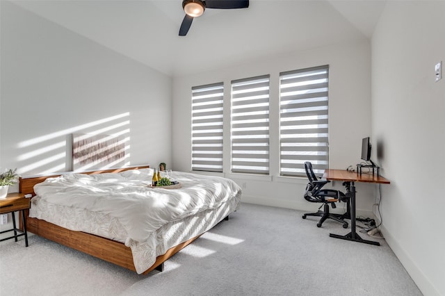 carpeted bedroom with a ceiling fan and baseboards