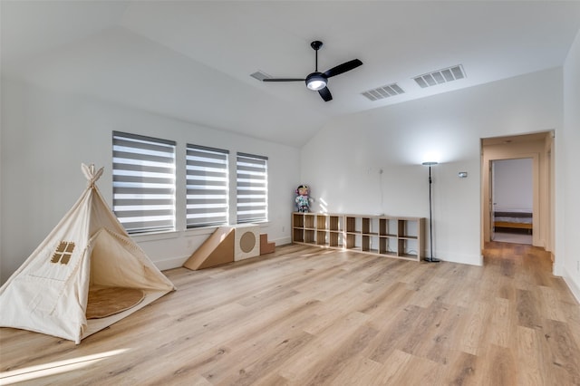 interior space with lofted ceiling, visible vents, a ceiling fan, light wood-type flooring, and baseboards