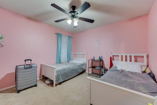 bedroom with light carpet, a textured ceiling, and a ceiling fan