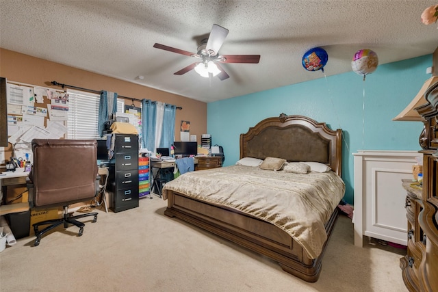 carpeted bedroom featuring ceiling fan and a textured ceiling