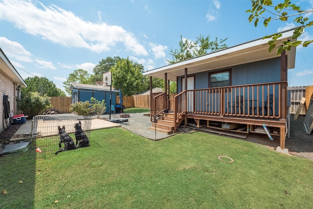 rear view of house with a patio area, a fenced backyard, a deck, and a lawn