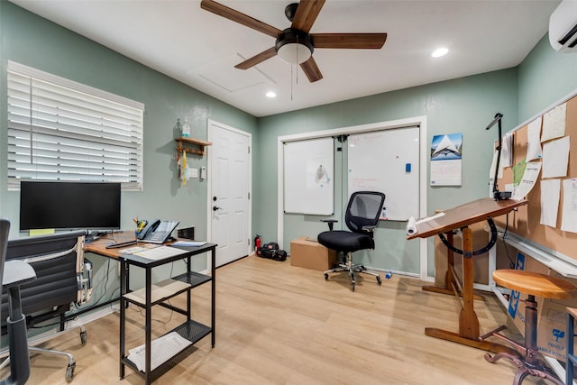 office featuring recessed lighting, a wall mounted AC, light wood-style floors, ceiling fan, and baseboards