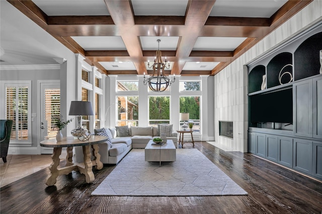 living room featuring coffered ceiling, dark wood-style floors, beamed ceiling, an inviting chandelier, and a fireplace