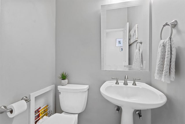 bathroom featuring toilet and a sink