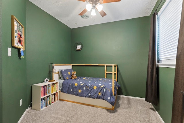 bedroom featuring a textured ceiling, multiple windows, and carpet