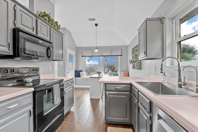 kitchen with black appliances, gray cabinets, light countertops, and visible vents