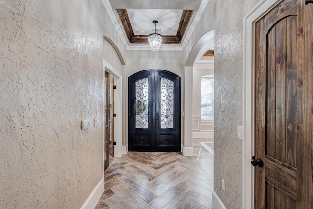 7101 Bridges Ave, Richland Hills, TX 76118 - entryway featuring arched walkways, french doors, a textured wall, ornamental molding, and baseboards