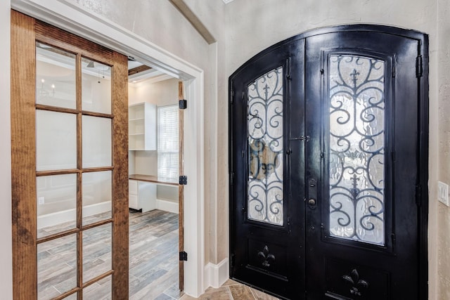 7101 Bridges Ave, Richland Hills, TX 76118 - entryway featuring arched walkways, french doors, wood finished floors, and baseboards