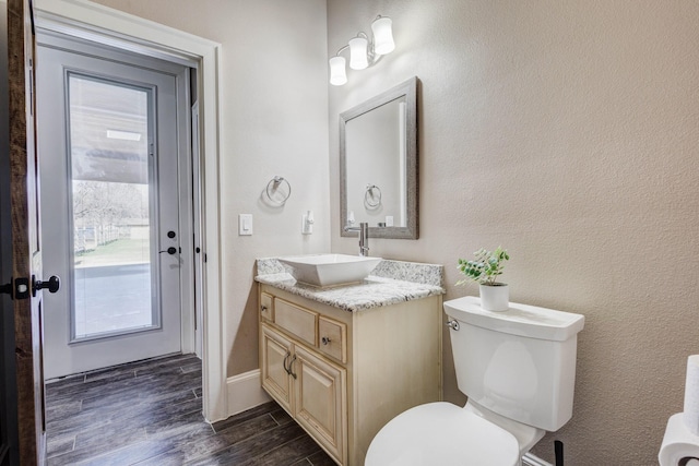 7101 Bridges Ave, Richland Hills, TX 76118 - bathroom with toilet, plenty of natural light, wood finished floors, and vanity