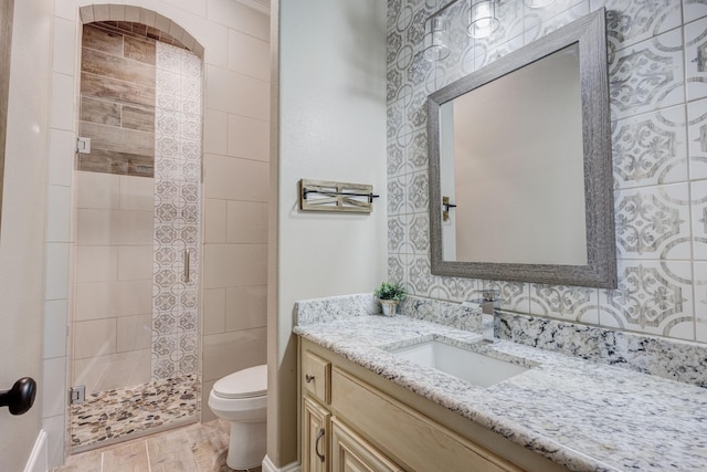 7101 Bridges Ave, Richland Hills, TX 76118 - full bathroom with a stall shower, vanity, toilet, and wood finished floors