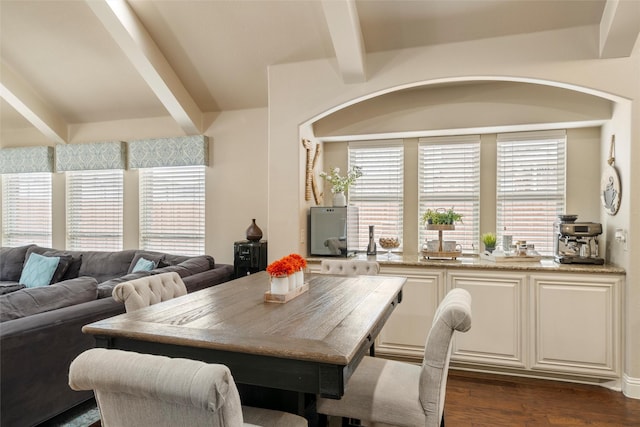 dining area featuring dark wood finished floors and beam ceiling