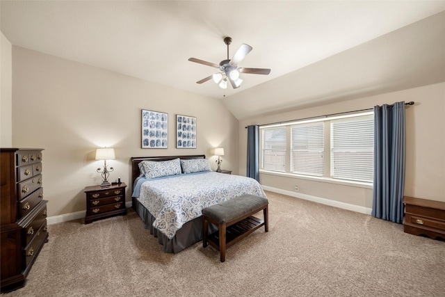 carpeted bedroom featuring vaulted ceiling, a ceiling fan, and baseboards