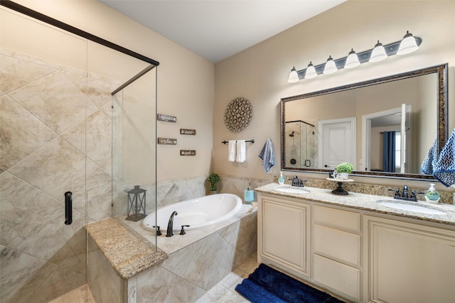 bathroom featuring a stall shower, a garden tub, and a sink