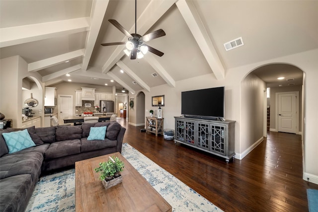 living area featuring visible vents, arched walkways, lofted ceiling with beams, dark wood-style floors, and ceiling fan