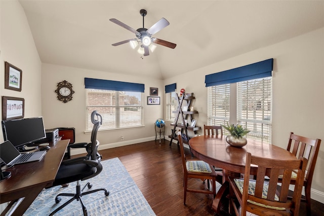 home office featuring dark wood-type flooring, a wealth of natural light, vaulted ceiling, and baseboards