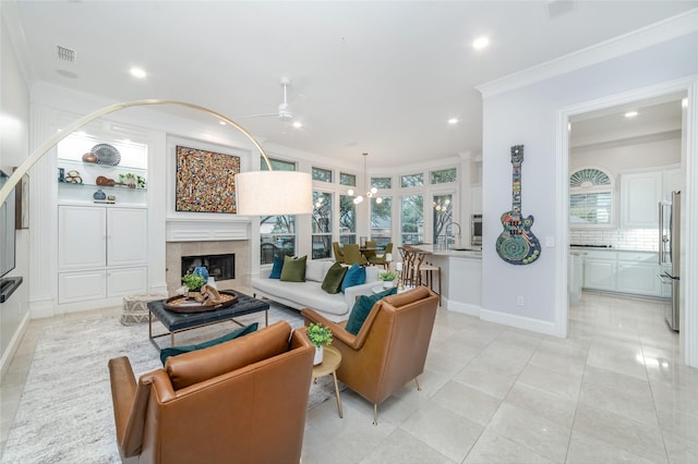 living area with ceiling fan, recessed lighting, a fireplace, visible vents, and crown molding