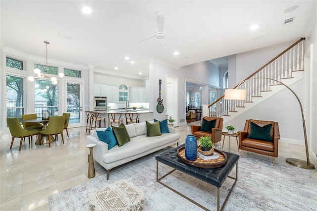 living room with a chandelier, recessed lighting, visible vents, ornamental molding, and stairway