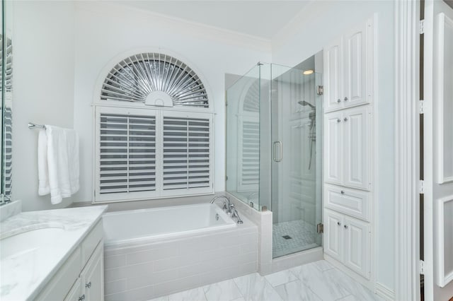 full bathroom featuring a garden tub, a shower stall, ornamental molding, and vanity