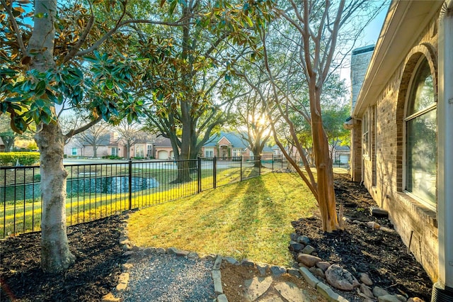 view of yard featuring a fenced backyard and a residential view