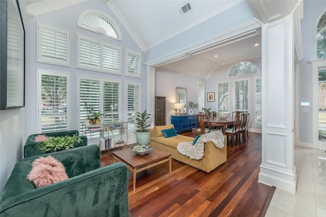 sunroom with lofted ceiling, visible vents, and ornate columns